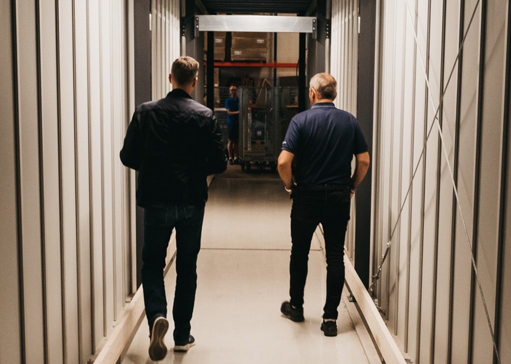 GS Bildeler co-founder, Trond Gule, and Element Logic Sales Manager, Øyvind Kollerud, walks through the custom-made tunnel through the AutoStore-system in the Oslo-warehouse.